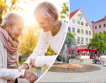 Startseite Slider 2_Mobil Ältere Frau stützt eine alte Dame. Stadtbild mit Springbrunnen.